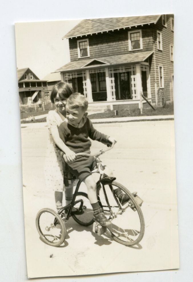 Little Bobby on a tricycle (note the decorative porch treatment in the background)