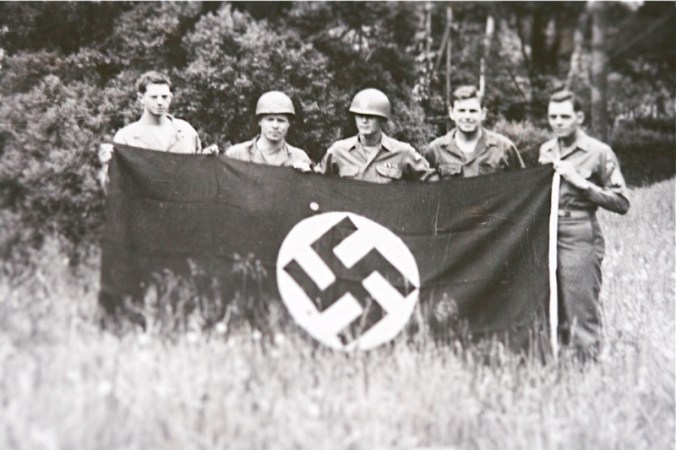 Amby (second from right) Holds a Captured German Flag in Leipzig