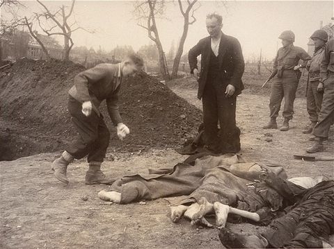 A Polish boy and his father bury the body of the boy's grandmother, who died in the Nordhausen c