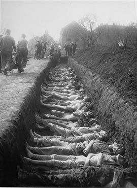 German civilians from the town of Nordhausen bury the bodies of former prisoners